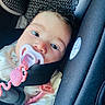 Evelyna joined the competition — help win amazing prizes! baby, pacifier, car_seat, child, face, close_up, curly_hair, safety_strap, infant, cute, pink, seat, young_child, portrait, baby_clothing, indoors, resting, expression, head, comfort