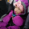 Aurelia is registered to the contest to win money with this photo: baby, child, car_seat, purple_clothing, mittens, headband, pink_bow, pacifier, safety_harness, infant, closeup, winter_clothing, cute, bundledup, portrait, seatbelt, indoor, expression, face, young_child