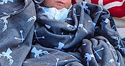 Whitley joined the competition — help win amazing prizes! baby, newborn, blanket, wrapped, sleeping, face, infant, cozy, soft, red, white, gray, pattern, arrow, fleece, resting, peaceful, closeup, portrait, child