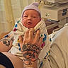 Whitley is registered to the contest to win money with this photo: newborn, baby, hospital, tattoo, hand, blanket, hat, person, infant, bed, medical, wristband, patient, care, room, hospital_bassinet, cloth, skin, holding, rest