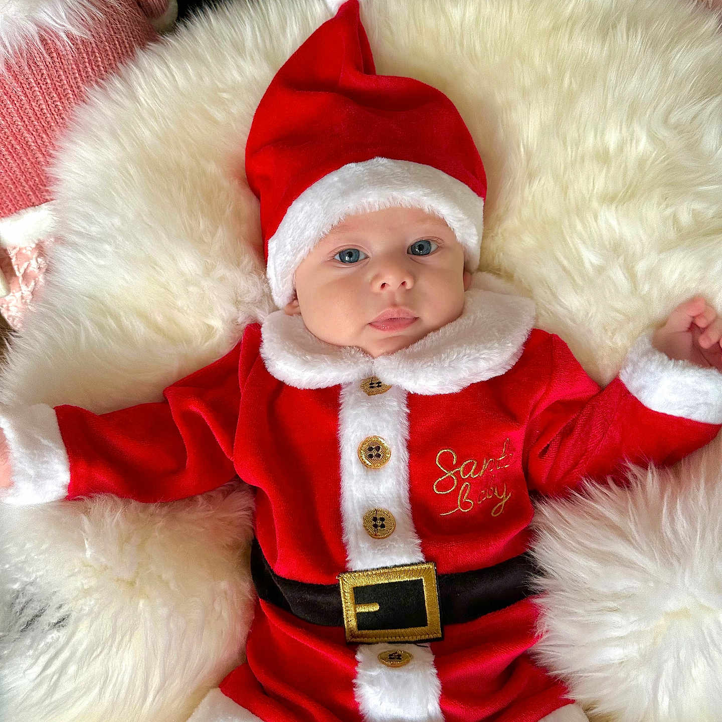 Adam is registered to the contest to win money with this photo: baby, blue_eyes, child, christmas, christmas_costume, cozy, cute, festive, fluffy_cushion, holiday, holiday_season, indoors, infant, portrait, red_clothing, santa_hat, smiling, soft_texture, warm, white_fur_trim