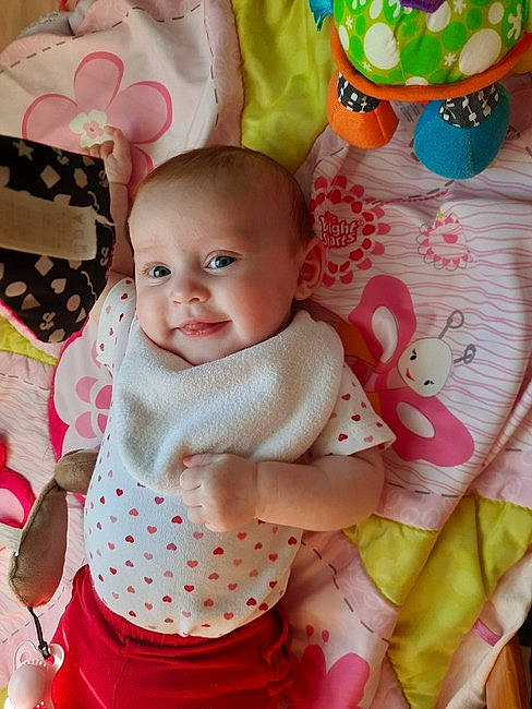 Kenslee is registered to the contest to win money with this photo: baby, baby_products, baby_toddler_clothing, baby_toys, cheek, child, event, happy, linens, pattern, peach, person, pink, play, room, sitting, skin, sleeve, smile, textile