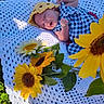 baby, sleeping, yellow_hat, blue_dress, white_blanket, crocheted_blanket, sunflowers, flowers, green_grass, outdoor, nature, peaceful, infant, cute, portrait, sunlight, relaxing, flora, headwear, child