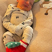 Remi joined the competition — help win amazing prizes! newborn, baby, sleeping, pajamas, red_socks, green_accents, soft_cushion, monkey_design, cozy, indoor, infant, cute, resting, child, home, blanket, comfort, peaceful, portrait, closeup