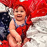 baby, child, smiling, red_bow, headband, bandana, patterned_fabric, colorful, blue, white, red, sitting, happy, cute, infant, portrait, hand, foot, clothing, indoors