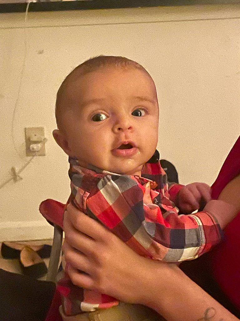 Leonidas joined the competition — help win amazing prizes! arm, baby, baby_toddler_clothing, cheek, chin, finger, flash_photography, gesture, hand, iris, lip, mouth, nail, neck, person, plaid, skin, sleeve, tartan, thumb