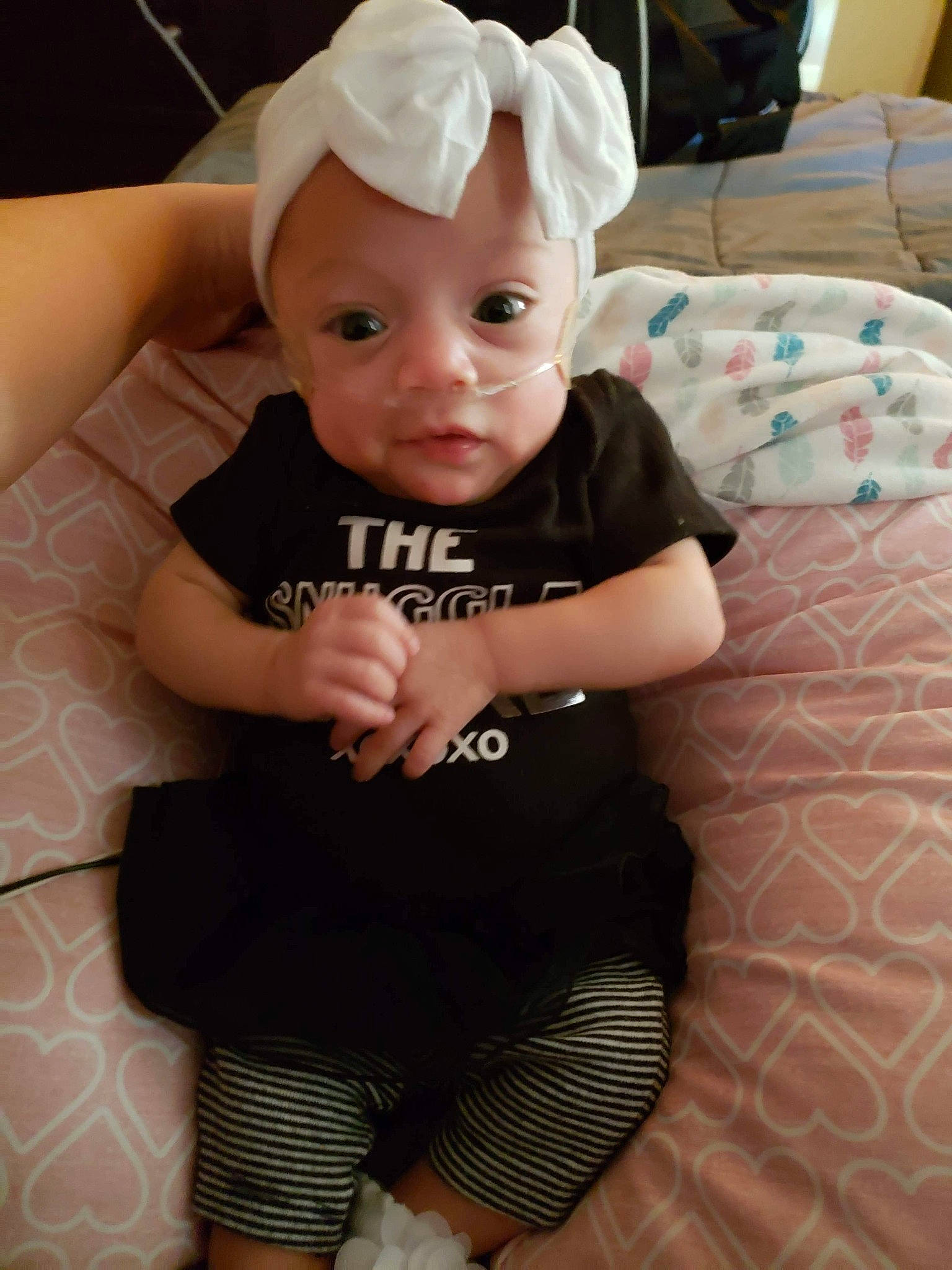 Joselyn is registered to the contest to win money with this photo: arm, baby, baby_products, baby_toddler_clothing, cheek, child, eye, hair_accessory, head, headgear, leg, person, pink, product, skin, toddler
