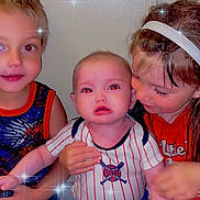 Sylas is registered to the contest to win money with this photo: child, baby, toddler, boy, girl, indoor, red_eye, sparkle_effect, clothing, headband, smile, pose, family, siblings, portrait, cute, expression, hand, hair, wall