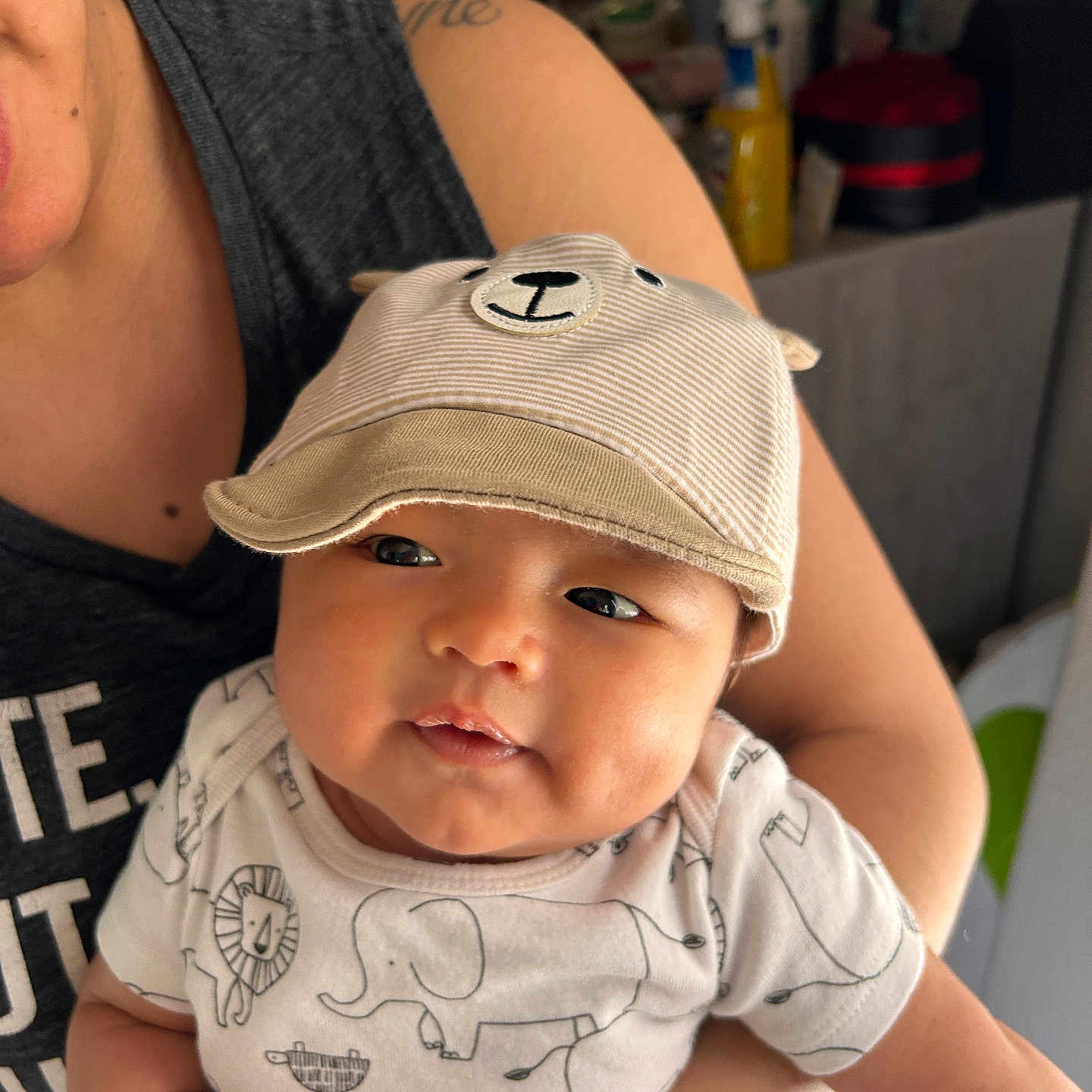 Theo is registered to the contest to win money with this photo: adult, baby, baseballcap, bodypart, bonnet, cap, clothing, face, finger, hand, hat, head, male, man, newborn, person, photography, portrait, sunhat, t_shirt