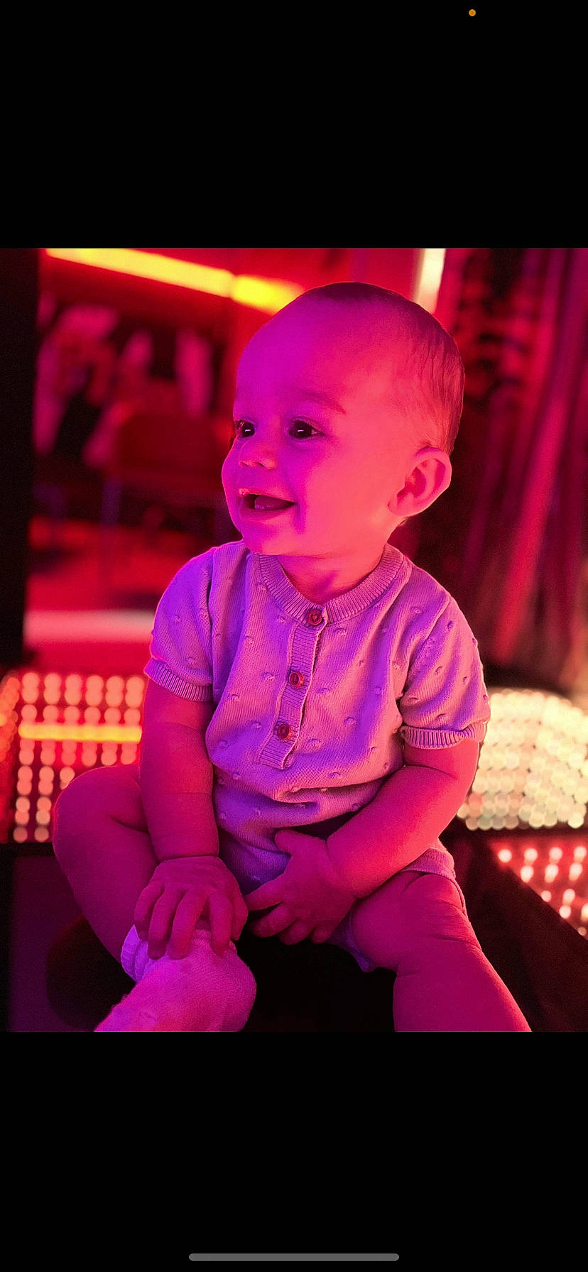 Kyree is registered to the contest to win money with this photo: baby, baby_toddler_clothing, child, electric_blue, entertainment, event, flash_photography, fun, happy, laugh, magenta, neon, performing_arts, person, pink, purple, sitting, smile, t_shirt, toddler