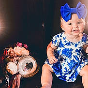 Magnolia is registered to the contest to win money with this photo: accessories, baby, clothing, costume, dress, face, flower, flowerarrangement, flowerbouquet, hat, head, indoors, jewelry, lighting, locket, pendant, person, photography, plant, portrait