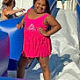 backyard, barbie, child, fence, fun, girl, happy, inflatable, outdoor, person, pink, play, smile, summer, sunlight, swimsuit, tree, water, water_slide, woman