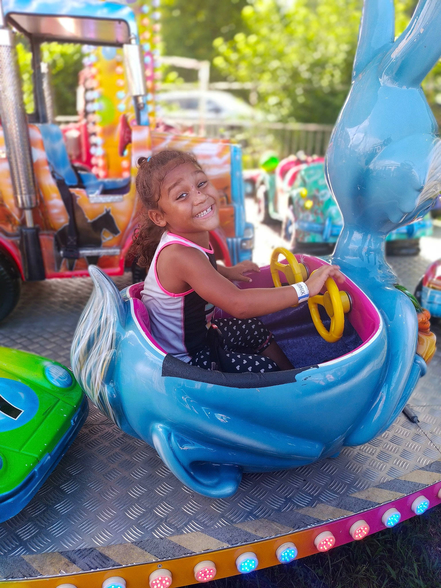 Isabella Rose joined the competition — help win amazing prizes! automotive_tire, blue, bumper, child, city, electric_blue, event, fun, happy, human_settlement, joy, leisure, outdoor_play_equipment, outdoor_recreation, person, play, playground, recreation, smile, summer