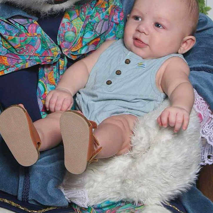 Carson joined the competition — help win amazing prizes! baby, chair, clothing, couch, cushion, dress, face, footwear, furniture, head, homedecor, jeans, newborn, pants, person, photography, portrait, sandal, shoe, sitting