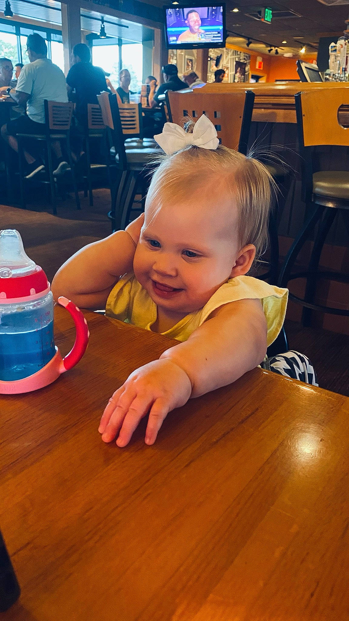 Jade is registered to the contest to win money with this photo: baby, baby_toddler_clothing, blurred, chair, child, cone, desk, flooring, fun, furniture, happy, hardwood, lighting, person, sitting, skin, smile, table, toddler, varnish