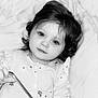 baby, child, infant, face, portrait, black_and_white, curly_hair, blanket, clothing, hand, eyes, cute, lying_down, soft_lighting, indoor, young_child, expressionless, peaceful, person, holding_object