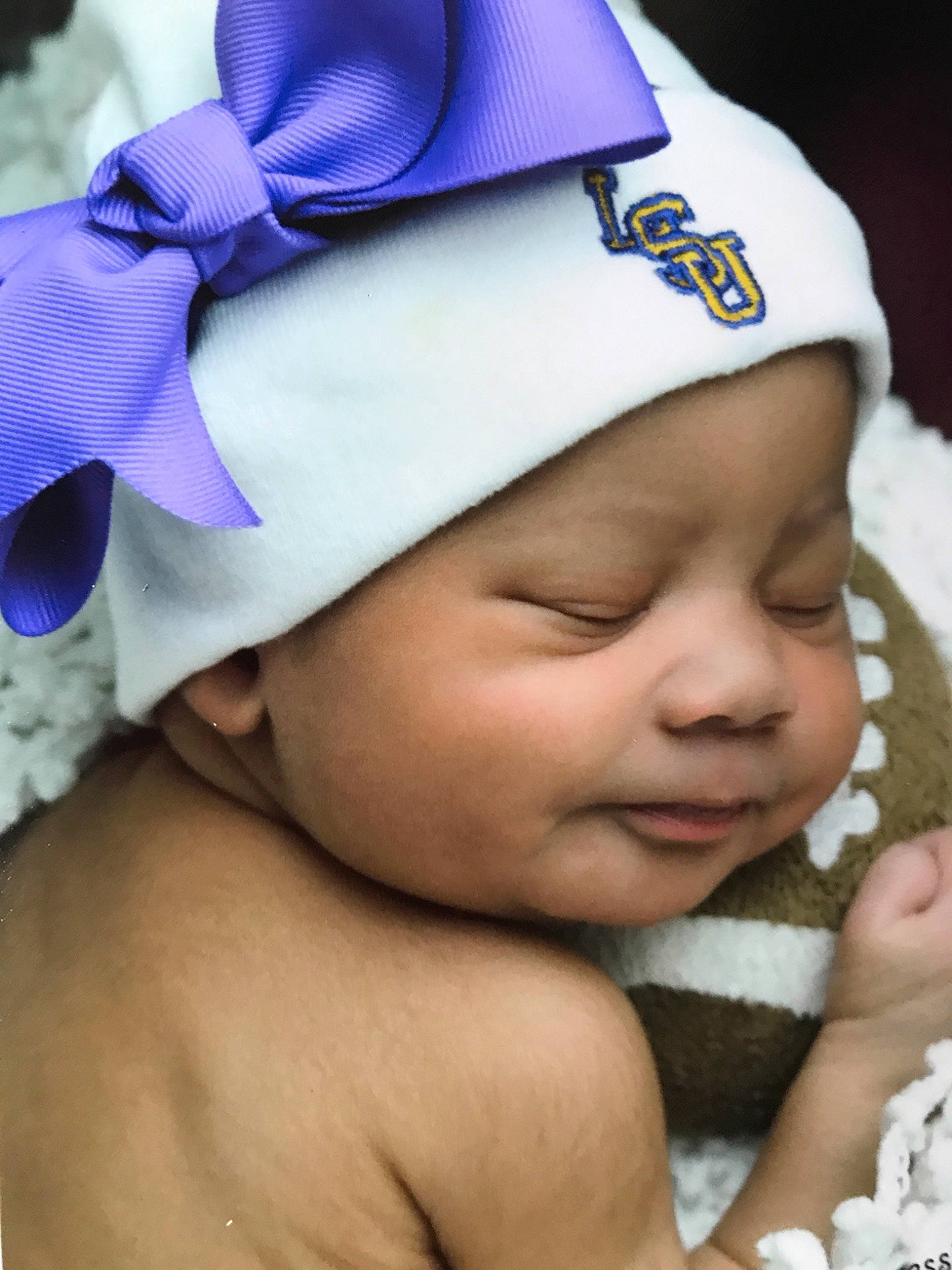 Alyvia is registered to the contest to win money with this photo: baby, blue, bonnet, cap, child, fashion_accessory, hair_accessory, hat, headgear, headwear, person, purple, smile, toddler