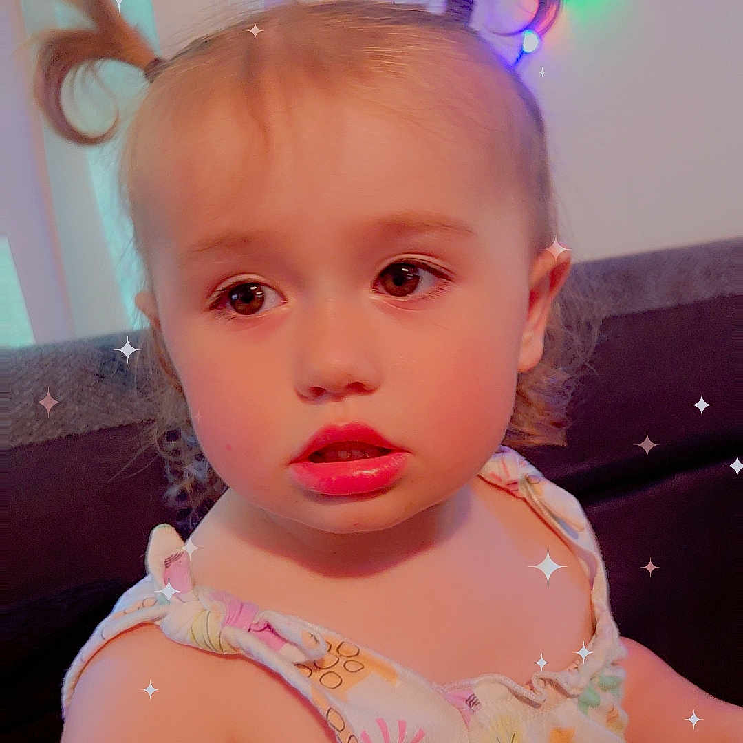 Tis joined the competition — help win amazing prizes! arm, baby, child, closeup, clothing, colorful, couch, curious, expression, face, hair, indoors, lights, pattern, pigtails, portrait, skin, sparkles, toddler, toy