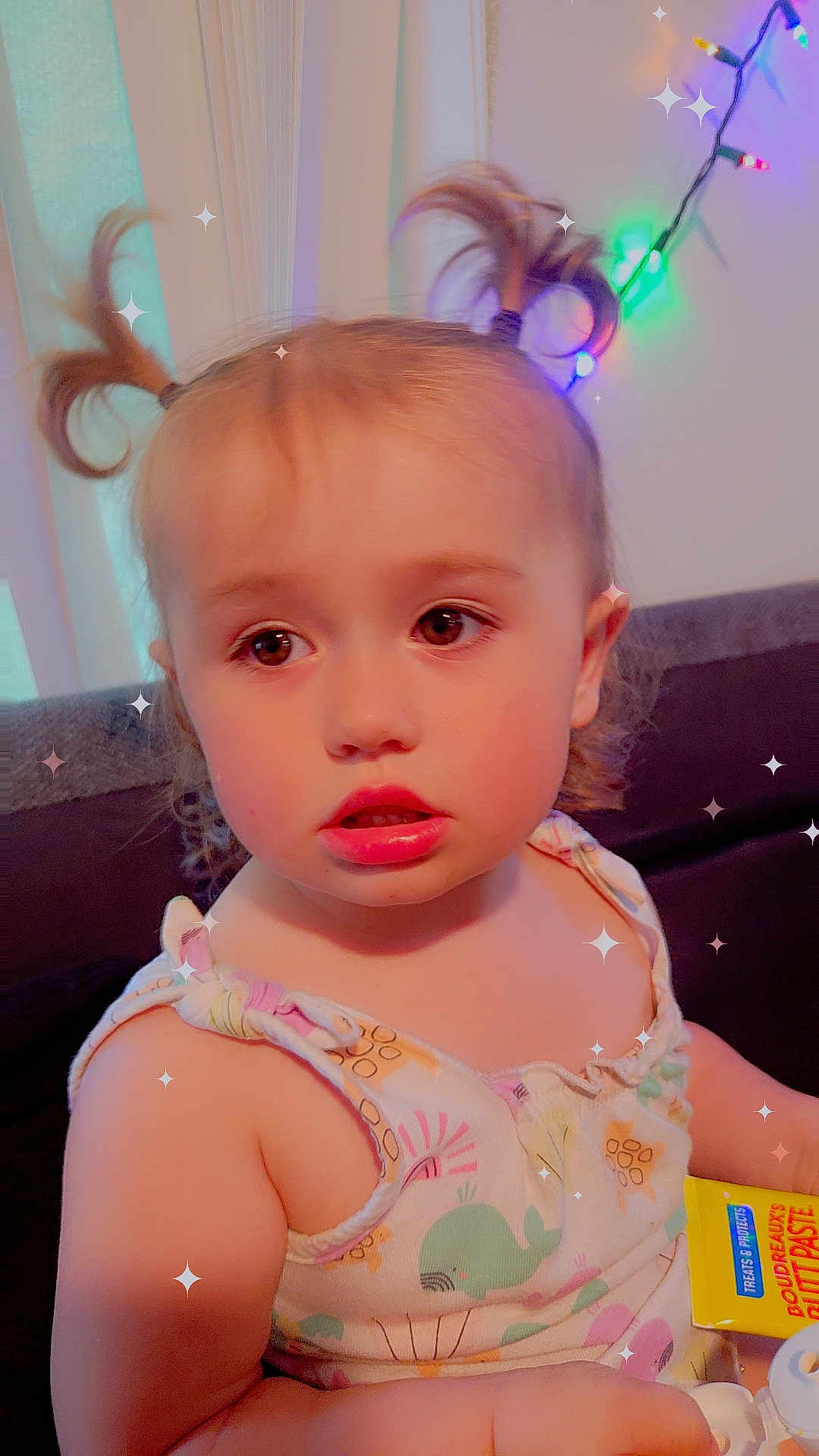 Tis joined the competition — help win amazing prizes! toddler, child, baby, face, hair, pigtails, curious, expression, indoors, couch, lights, colorful, sparkles, clothing, pattern, skin, arm, toy, closeup, portrait