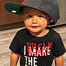 Alexander joined the competition — help win amazing prizes! child, toddler, baby, portrait, face, smiling, baseball_cap, black_shirt, graphic_t_shirt, clothing, indoor, hallway, wooden_door, floor, standing, close_up, fashion, cute, rebel, photography