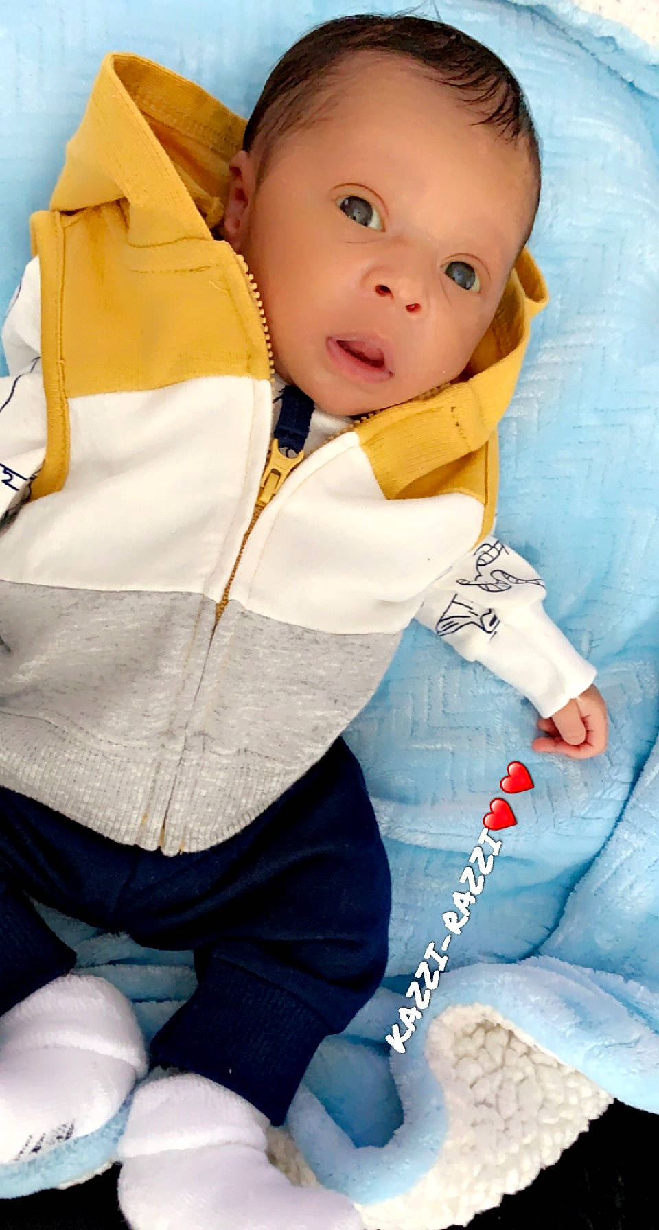 Khazir is registered to the contest to win money with this photo: baby, baby_products, baby_toddler_clothing, blue, cheek, child, collar, comfort, electric_blue, eye, fun, happy, head, linens, nose, person, sitting, skin, sleeve, toddler