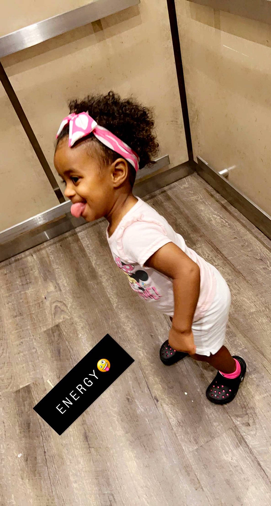 Kassidy is registered to the contest to win money with this photo: baby_toddler_clothing, baseball_cap, cap, child, flooring, footwear, fun, happy, hat, human_leg, magenta, person, play, sandal, smile, standing, t_shirt, toddler