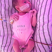 Ava joined the competition — help win amazing prizes! baby, newborn, infant, medical_tubes, pink_onesie, striped_blanket, lying_down, hospital, monitoring, face, hand, leg, cute, small, miracle, patient, tape, healthcare, soft_light, portrait