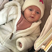 Ava joined the competition — help win amazing prizes! baby, blanket, child, clothing, comfort, cozy, cute, eyes, face, fuzzy_jacket, hand, hat, indoor, infant, jacket, knit_hat, person, soft_texture, stroller, warm