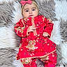 baby, infant, child, red_clothing, floral_pattern, headband, pink_bow, lying_down, soft_rug, gray_rug, white_rug, cute, portrait, indoors, fashion, adorable, small_hands, looking_at_camera, cozy, comfortable