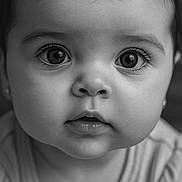 Fernanda is registered to the contest to win money with this photo: baby, black_and_white, child, close_up, clothing, cute, expression, eyelashes, eyes, face, hair, infant, innocence, lips, nostrils, person, portrait, skin, soft_light, young