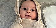 Barnaby is registered to the contest to win money with this photo: baby, towel, hood, wrapped, hand, curious, smile, face, infant, skin, blanket, soft, texture, indoors, person, cute, newborn, warm, child, portrait