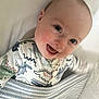 Barnaby joined the competition — help win amazing prizes! baby, smiling, blanket, onesie, dinosaur_pattern, happy, infant, cute, face, lying_down, child, bed, soft_lighting, cheerful, portrait, young, cozy, skin, head, expression