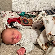 Tilly-Mae joined the competition — help win amazing prizes! baby, newborn, sleeping, blanket, couch, pillow, holiday, christmas, red_truck, infant, clothing, cozy, resting, soft, home, decor, peaceful, face, person, indoors