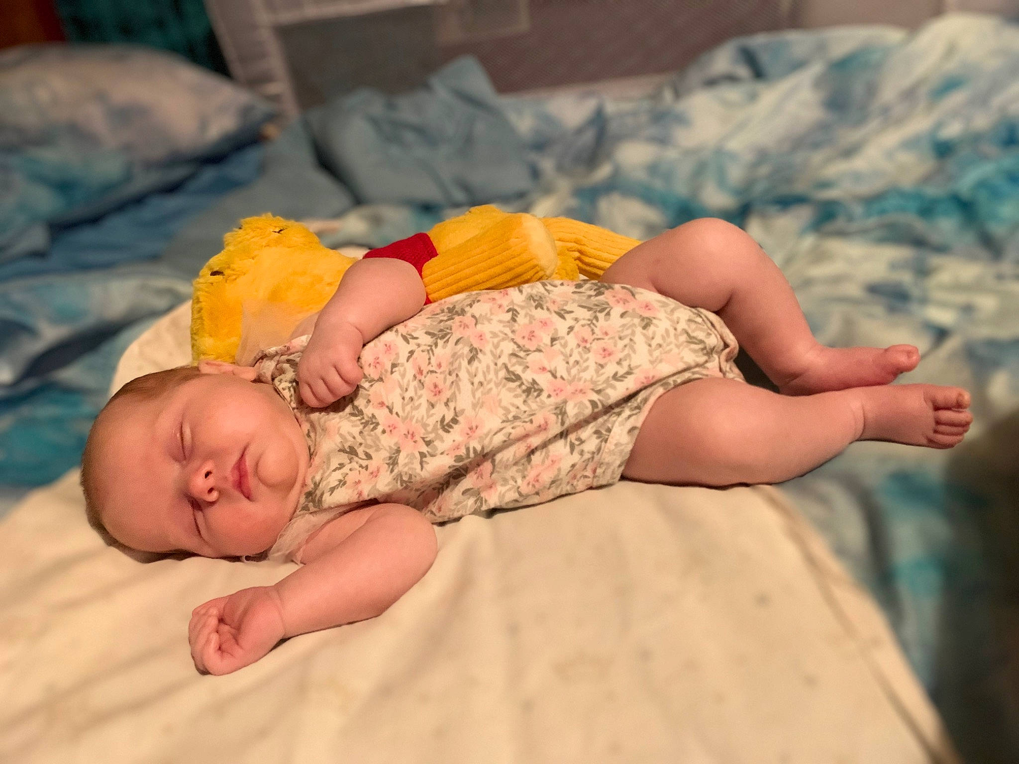 Lucy is registered to the contest to win money with this photo: abdomen, baby, baby_toddler_clothing, barefoot, child, comfort, finger, flooring, hair, hand, head, headgear, human_body, human_leg, knee, linens, person, skin, thigh, toddler