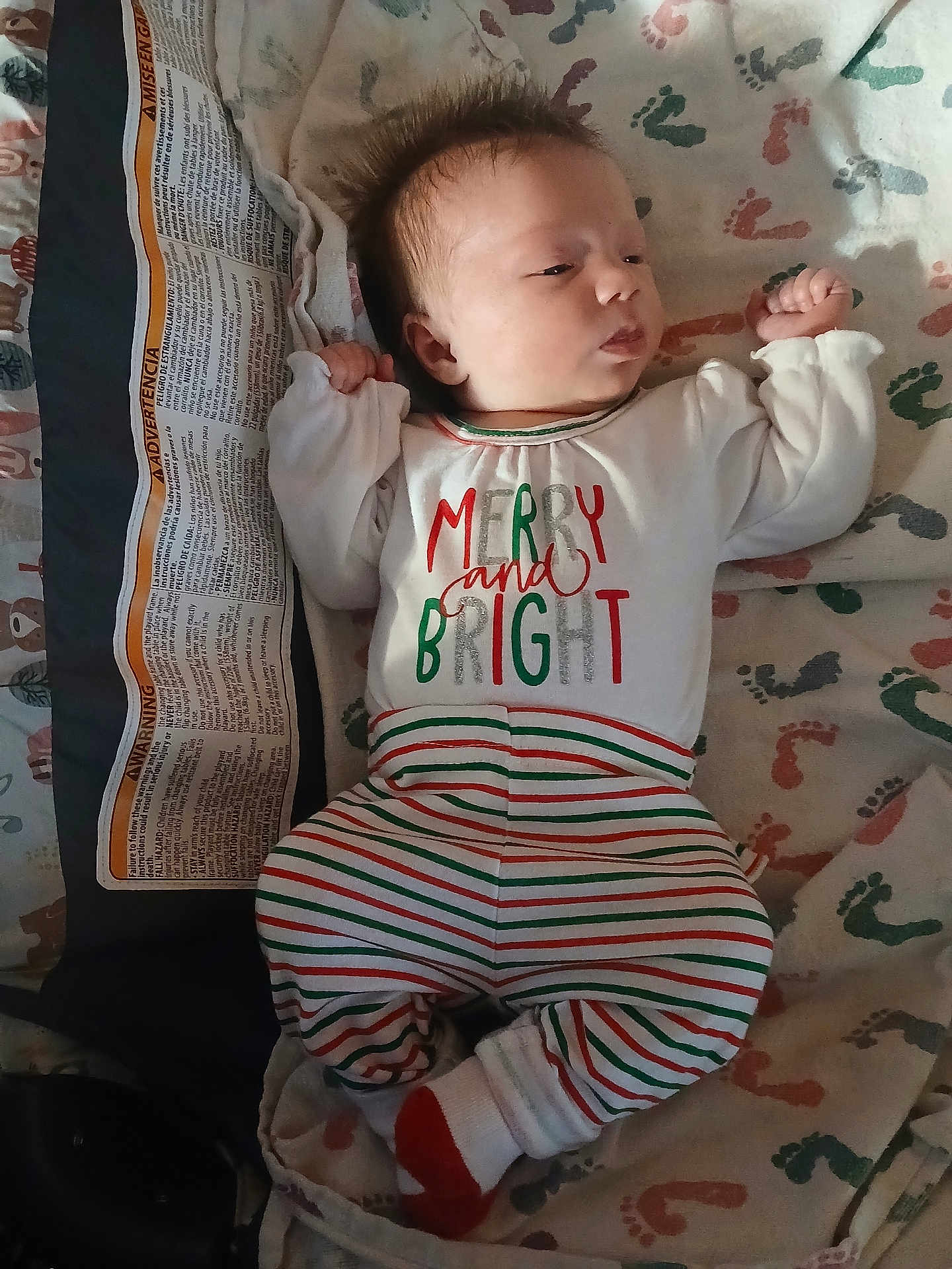 Chloe joined the competition — help win amazing prizes! baby, infant, pajamas, clothing, footprint_pattern, blanket, sleepwear, child, cute, newborn, portrait, person, lying_down, indoors, soft_lighting, striped_pants, white_socks, holiday_theme, sleepy, cozy