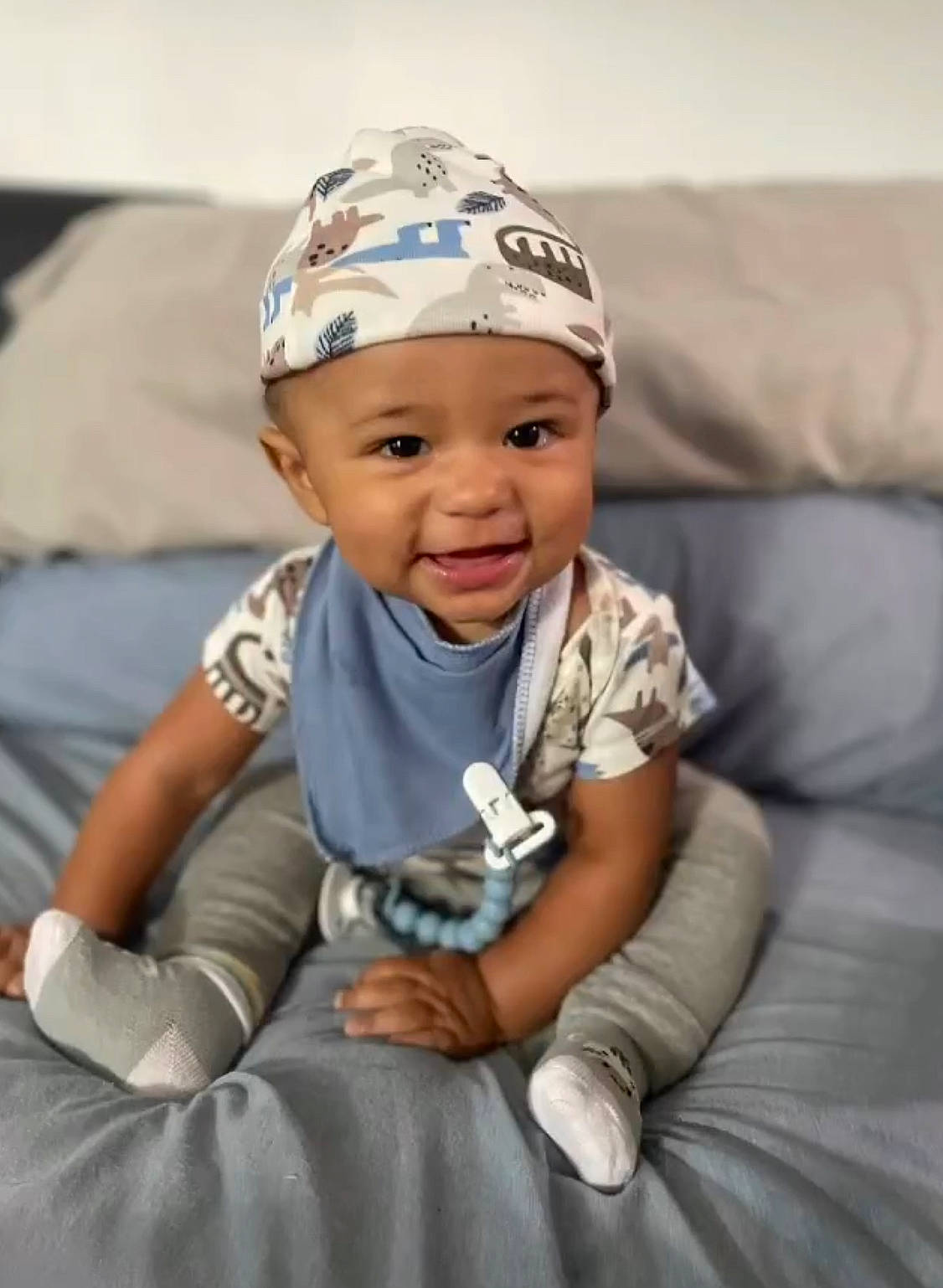 Kavani is registered to the contest to win money with this photo: baby, baby_toddler_clothing, baseball_cap, beanie, cap, child, comfort, fashion_accessory, flash_photography, fun, happy, headwear, laugh, person, personal_protective_equipment, photo_shoot, portrait_photography, sitting, sleeve, smile