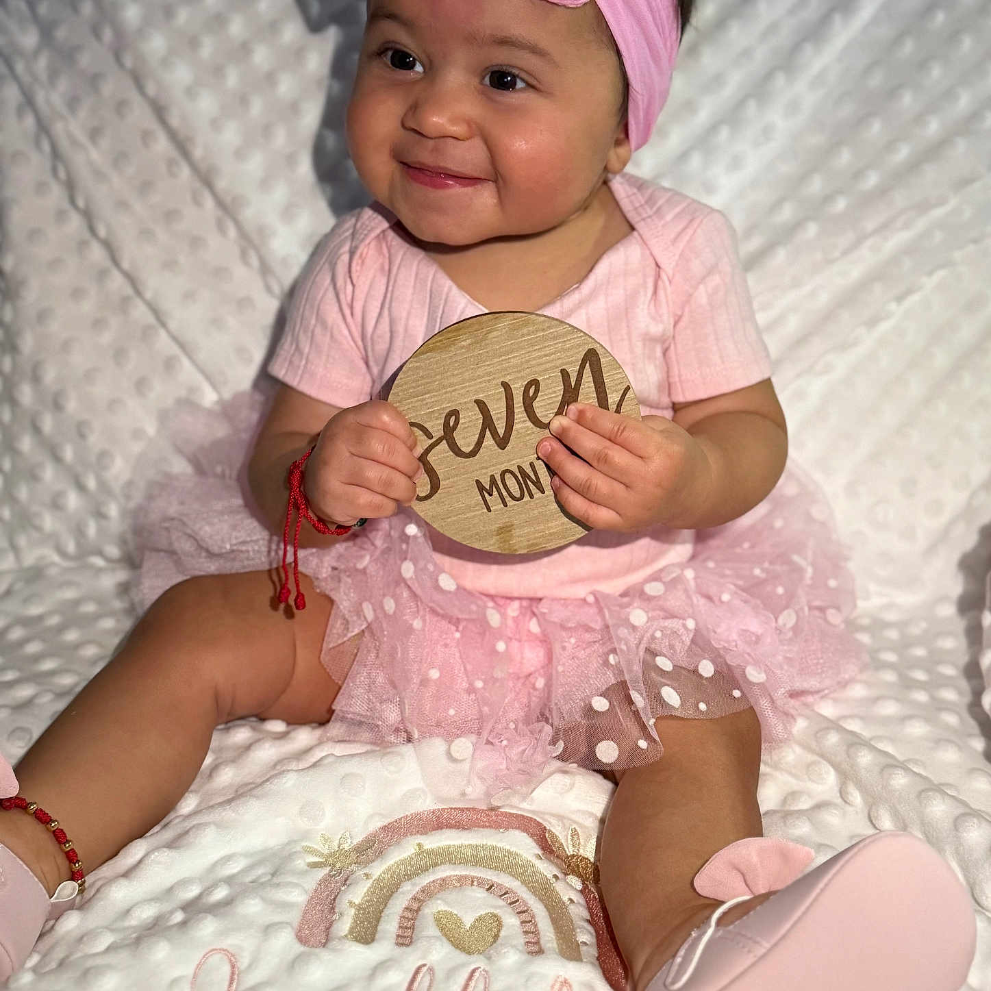 Leahlidiya joined the competition — help win amazing prizes! baby, blanket, bracelet, child, cute, embroidery, footwear, happy, headband, indoors, infant, pink_clothing, plaque, portrait, rainbow, seven_months, sitting, smile, soft_texture, tutu_skirt
