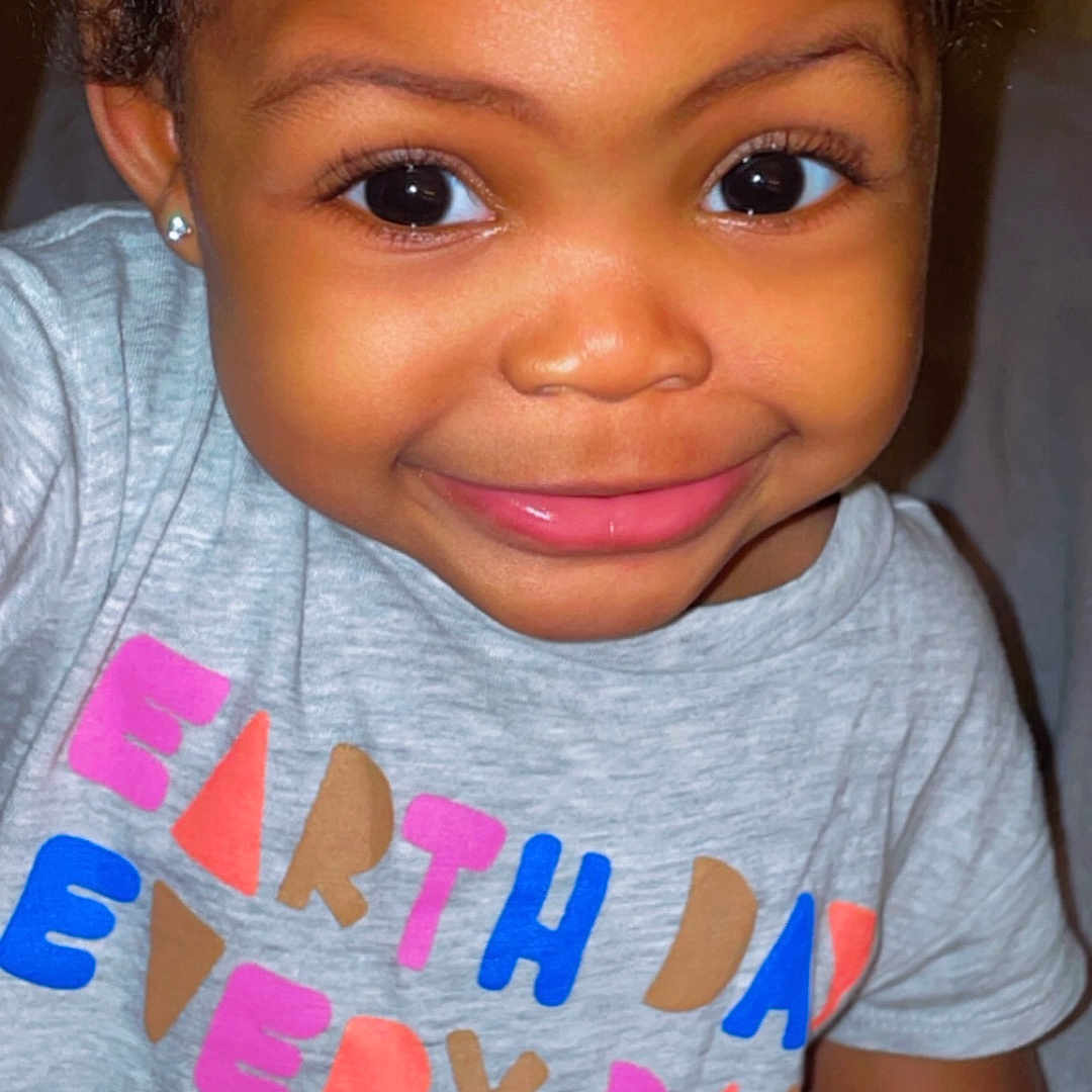 Laila is registered to the contest to win money with this photo: accessories, baby, bodypart, clothing, cosmetics, earring, face, happy, head, jewelry, lipstick, mouth, person, photography, portrait, shirt, skin, smile, t_shirt, teeth