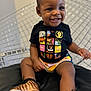 Laila is registered to the contest to win money with this photo: baby, babylaughing, ball, clothing, face, football, footwear, happy, head, pants, person, photography, portrait, shoe, shorts, sitting, sleeve, smile, sneaker, t_shirt