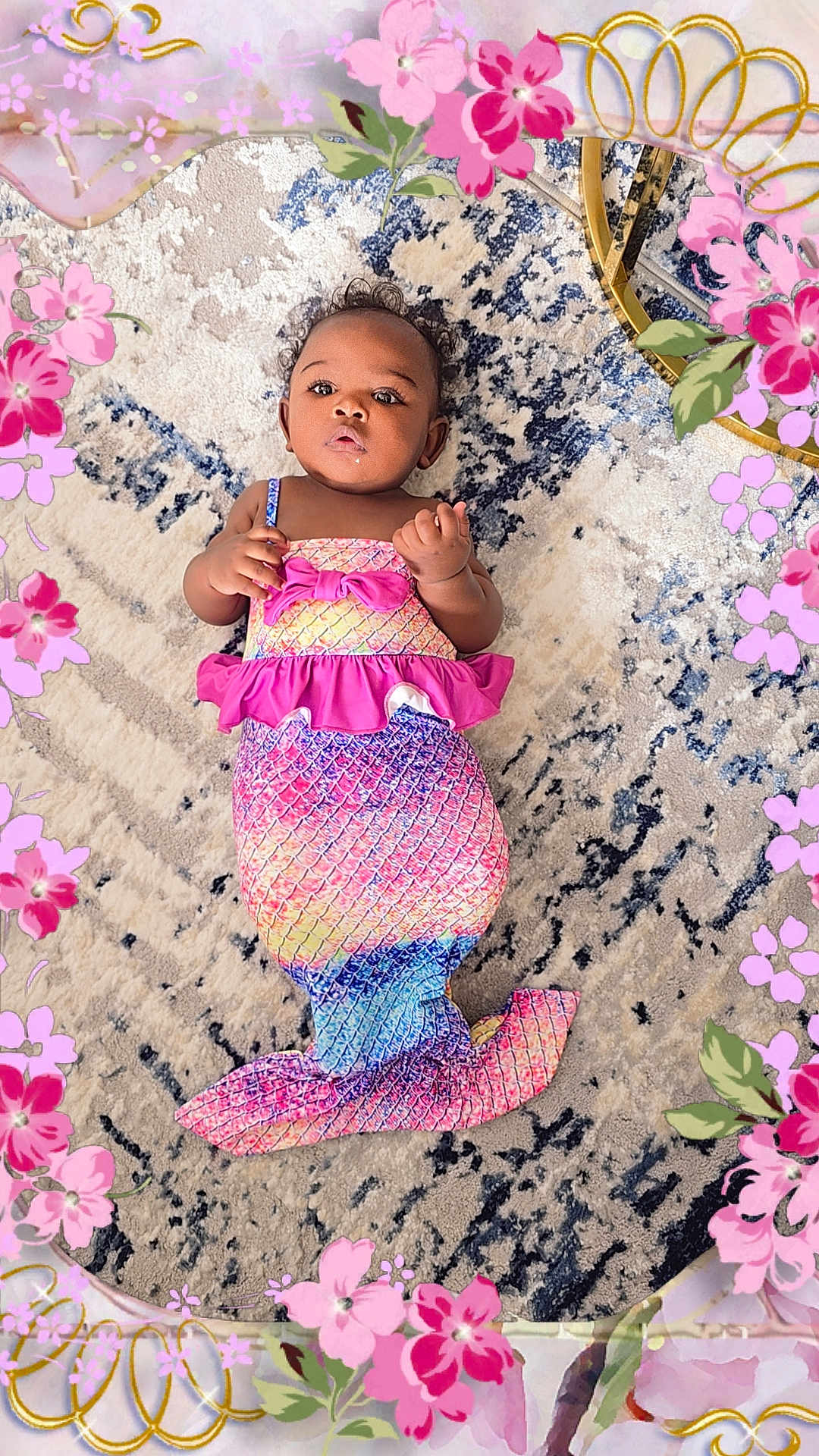 Anahya a rejoint le concours — aidez-le/la à gagner de superbes lots ! adorable, baby, carpet, child, clothing, colorful, costume, cute, decorative, fantasy, floral_border, indoor, infant, lying_down, mermaid_costume, patterned_rug, pink, playful, portrait, purple