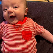 Cyrus joined the competition — help win amazing prizes! baby, blanket, child, cute, face, floor, green, happy, head, indoors, infant, lying_down, pajamas, person, portrait, red, smiling, striped_clothing, wooden_floor, young_child