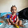 baby, babylaughing, bed, bedroom, clothing, cushion, face, furniture, happy, head, homedecor, indoors, person, photography, portrait, quilt, room, sitting, sleeve, smile