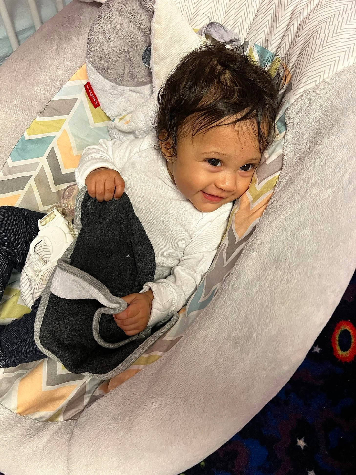 Gianna is registered to the contest to win money with this photo: arm, auto_part, automotive_tire, automotive_wheel_system, baby, baby_carriage, baby_products, child, circle, comfort, flooring, happy, joy, leisure, linens, pattern, person, sitting, smile, t_shirt