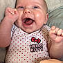 baby, infant, smiling, happy, onesie, hello_kitty, polka_dots, cheeks, face, hands, bed, blanket, soft, candid, cute, child, portrait, indoor, person, expression