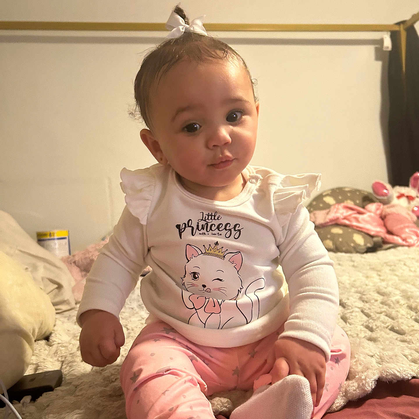 Ezmerai joined the competition — help win amazing prizes! baby, child, infant, girl, sitting, bed, pajamas, pink, white, bow, cute, clothing, face, portrait, indoor, soft_lighting, expression, cozy, blanket, toy