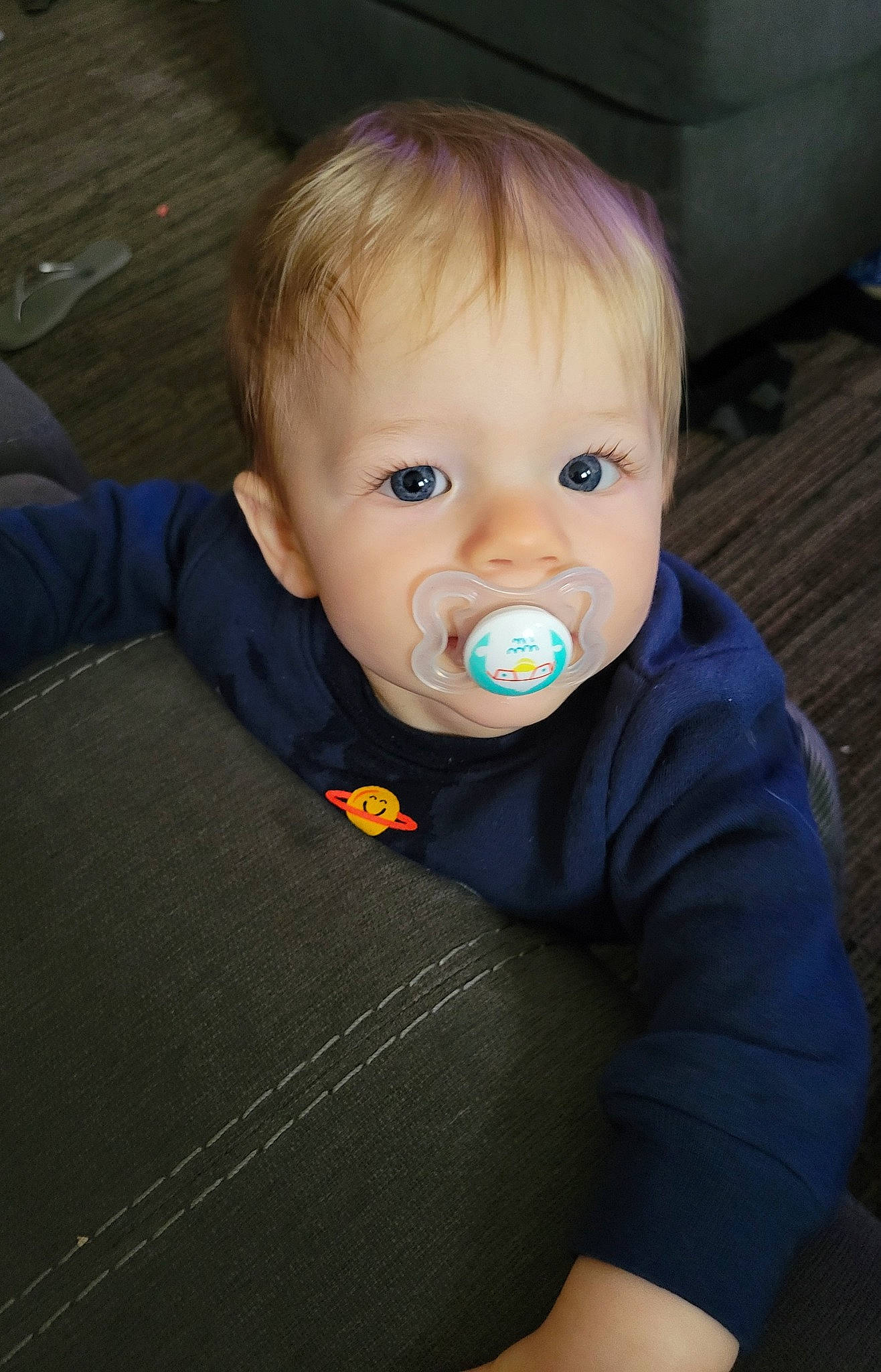 Fletcher is registered to the contest to win money with this photo: baby, baby_products, baby_toddler_clothing, cheek, child, comfort, electric_blue, eye, eyebrow, flash_photography, fun, hair, happy, human_body, iris, nose, person, sitting, sleeve, t_shirt
