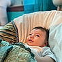 baby, blanket, chair, cozy, comfort, cute, face, infant, indoors, looking_up, portrait, resting, soft, smile, toddler, white_clothing, window, curtain, home, peaceful