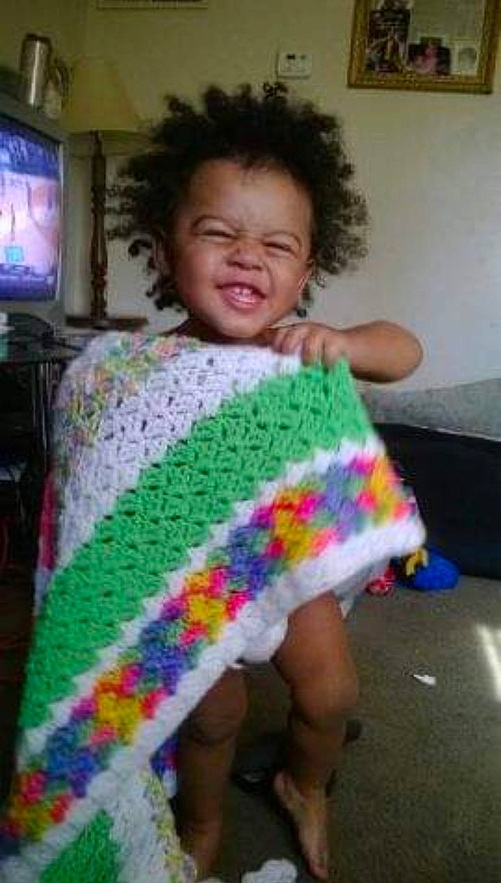 Malikeigh is registered to the contest to win money with this photo: art, baby_toddler_clothing, chair, child, fun, hair, happy, leg, linens, magenta, mammal, pattern, person, picture_frame, pink, sleeve, smile, t_shirt, television, television_set