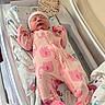 newborn, baby, infant, sleeping, pink, onesie, elephant_pattern, hat, bassinet, crib, blanket, nursery, hospital, birth_announcement, portrait, face, hands, zipper, indoors, cozy