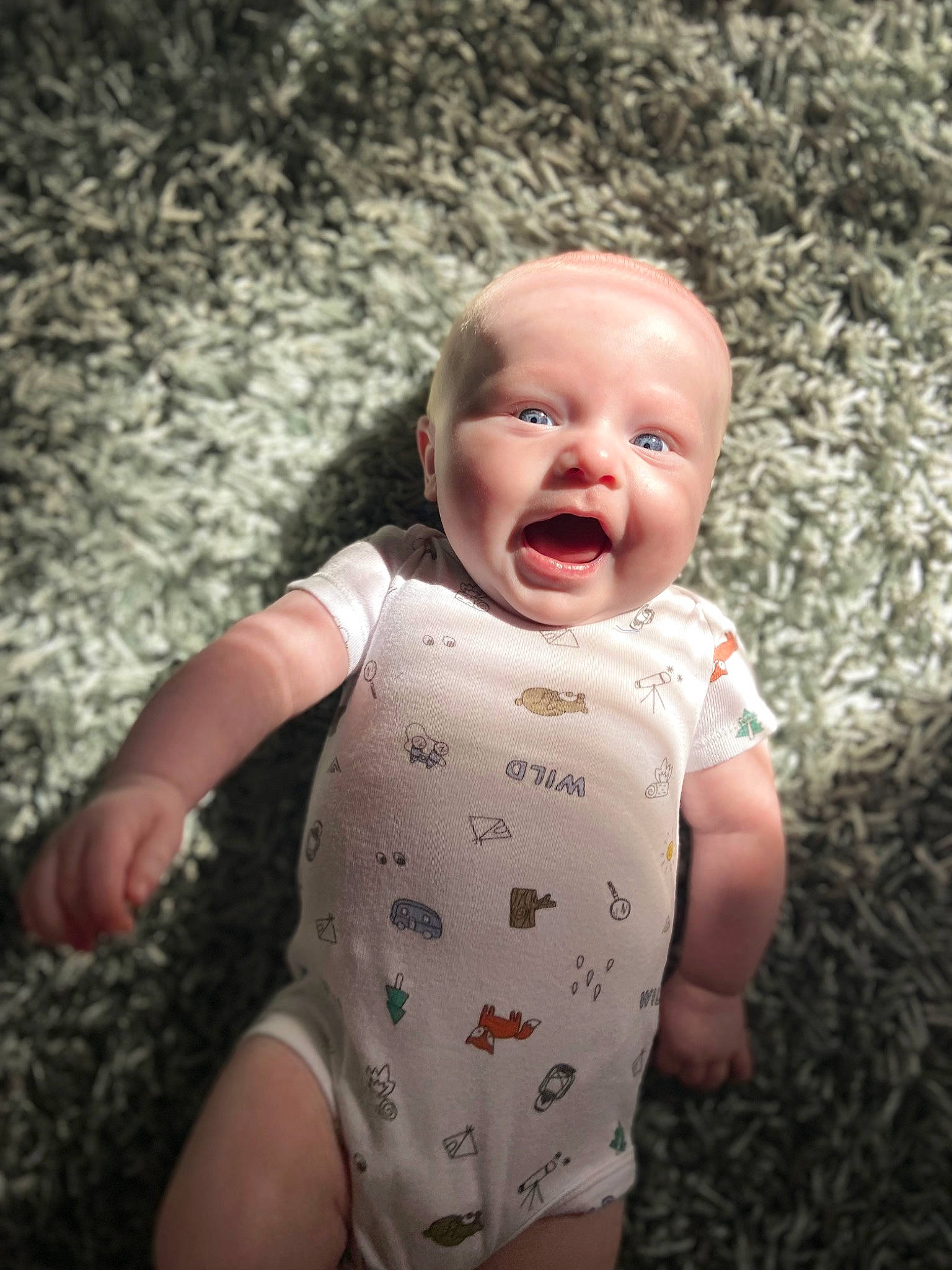 Bradley is registered to the contest to win money with this photo: baby, baby_toddler_clothing, cheek, chin, eye, face, flash_photography, gesture, grass, happy, head, iris, lip, mouth, nose, people_in_nature, person, skin, sleeve, smile